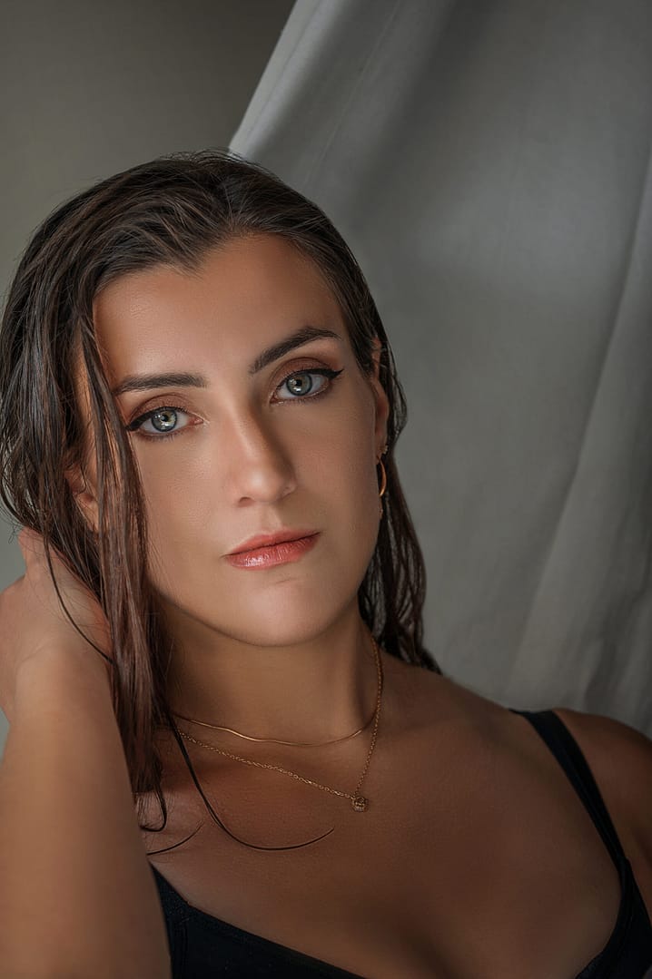 Close-up empowering boudoir portrait of woman with golden necklace, photography by Nickolaus21 Chicago